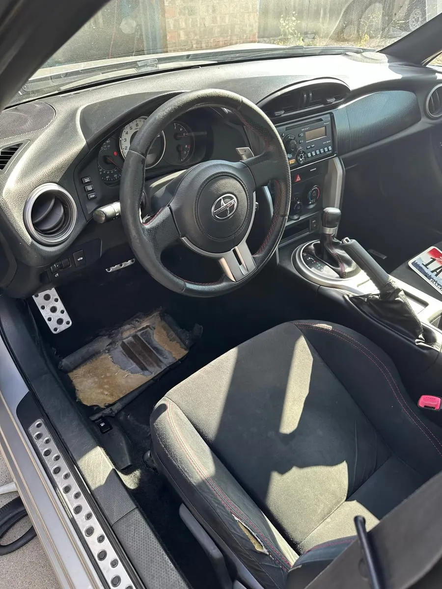 The same footwell after cleaning, carpet lifted and the alloy sill plate visible again