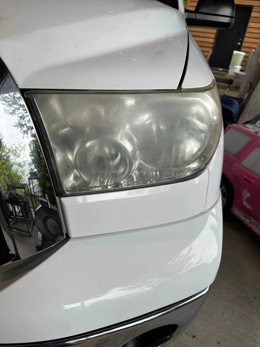 Toyota Tundra headlight clouded yellow-grey with oxidation, the reflector inside barely visible through the lens